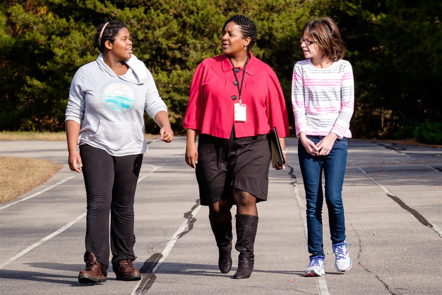School counselor walking and talking with students School counselor walking and talking with students
